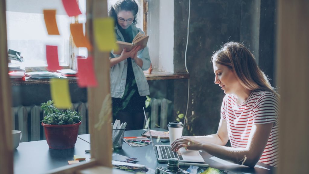 Two people work together in a modern office.
