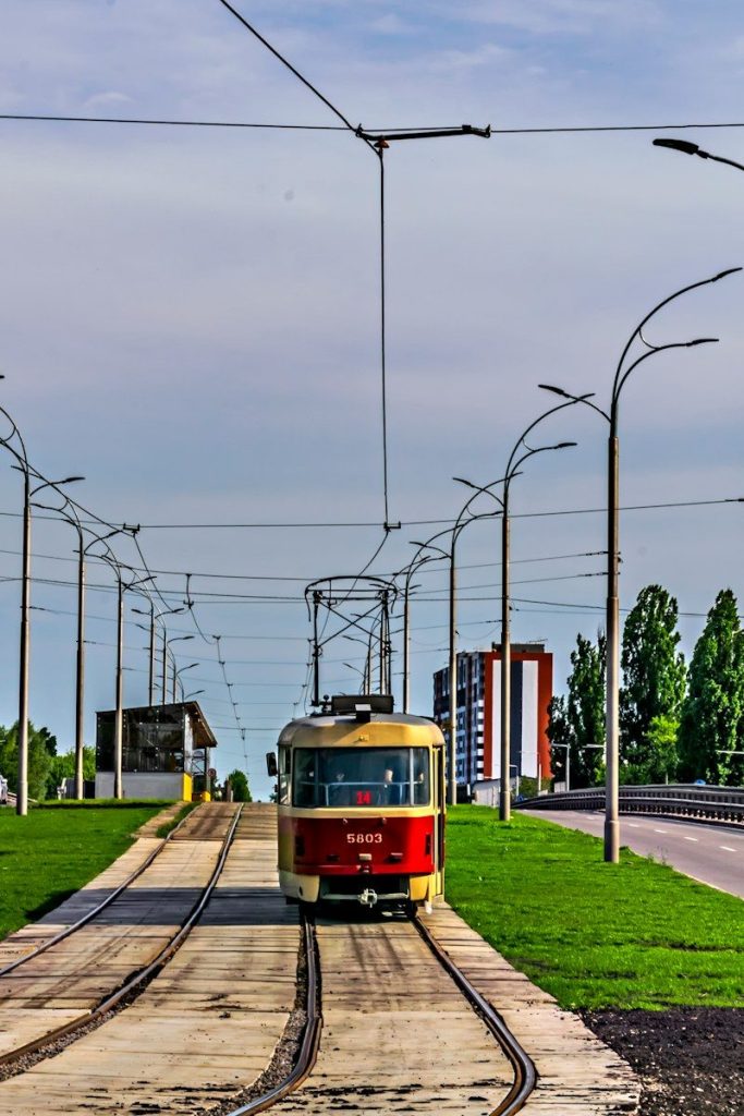 a red and yellow train traveling down train tracks